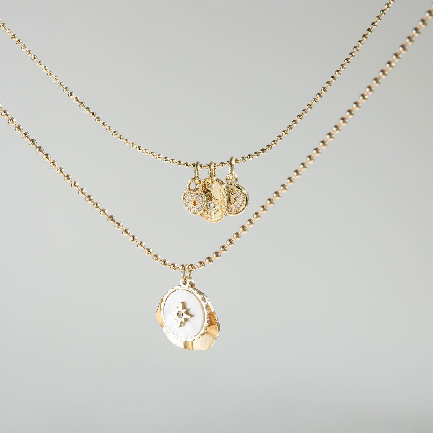 delicate chain with pearl coin compass and hammered gold charm